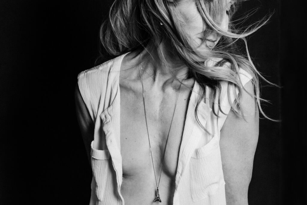 vancouver classy boudoir image of woman in an open vest revealing her tummy