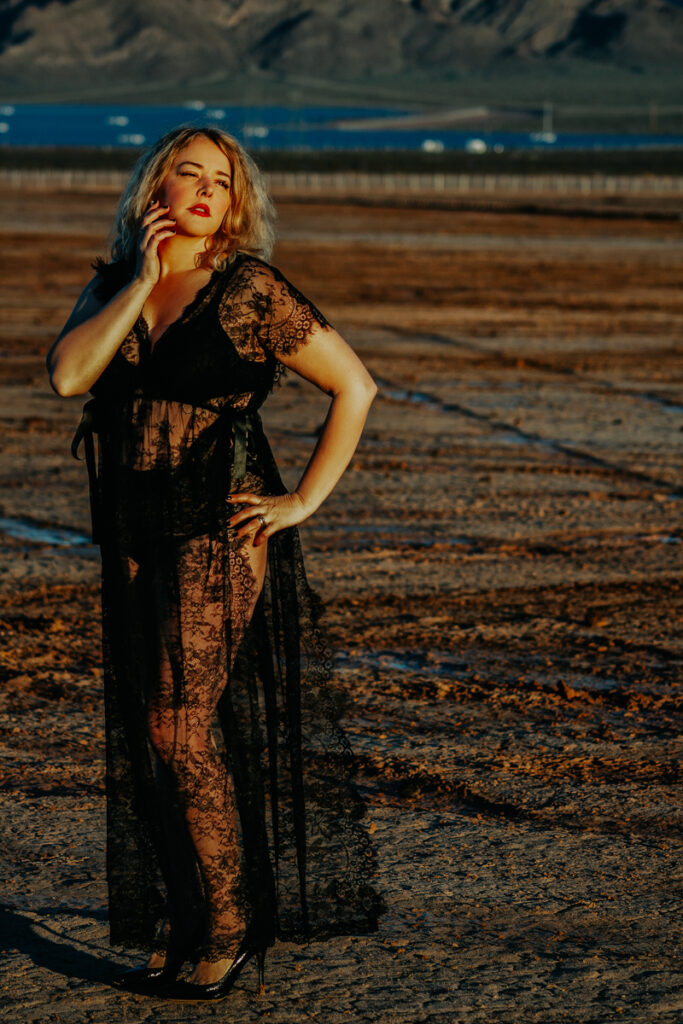Woman wearing lace outfit standing in the desert and living spontaneously doing a last minute boudoir shoot 