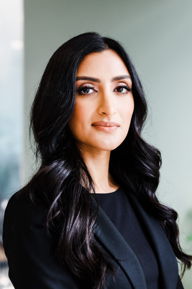 Headshots photo of a woman with black hair wearing a black top and blazer. Professional headshots coquitlam