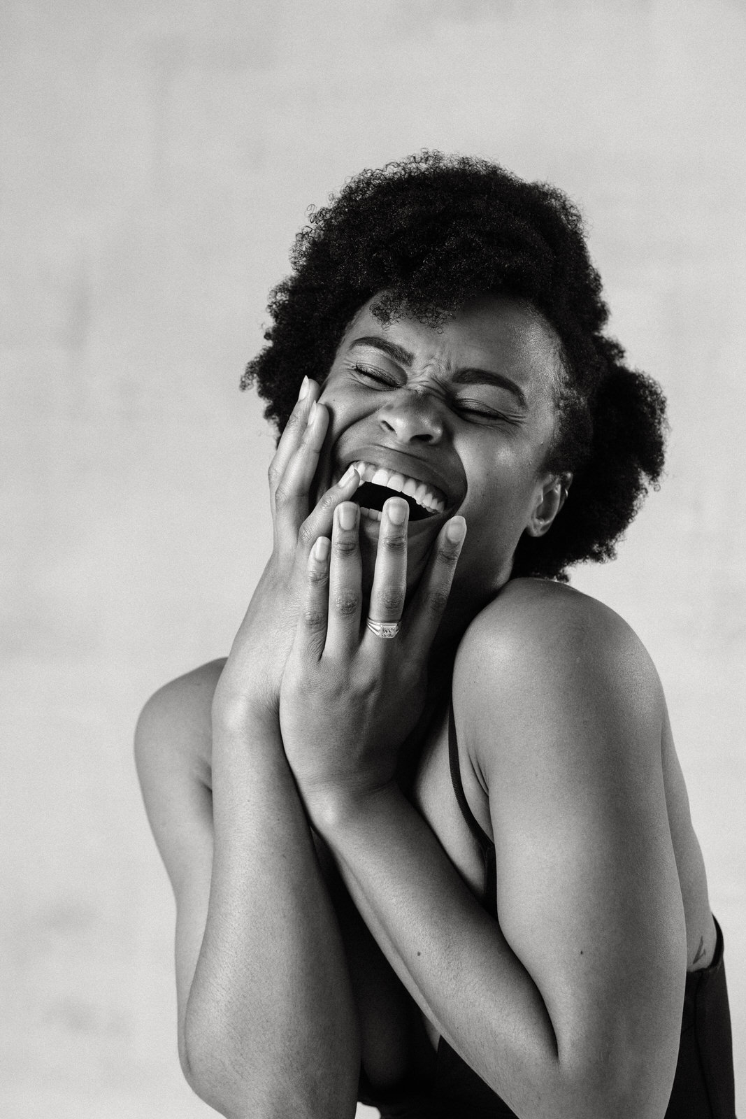 Portrait of a black woman with an afro laughing taken by Vancouver Portrait photographer Michele Mateus