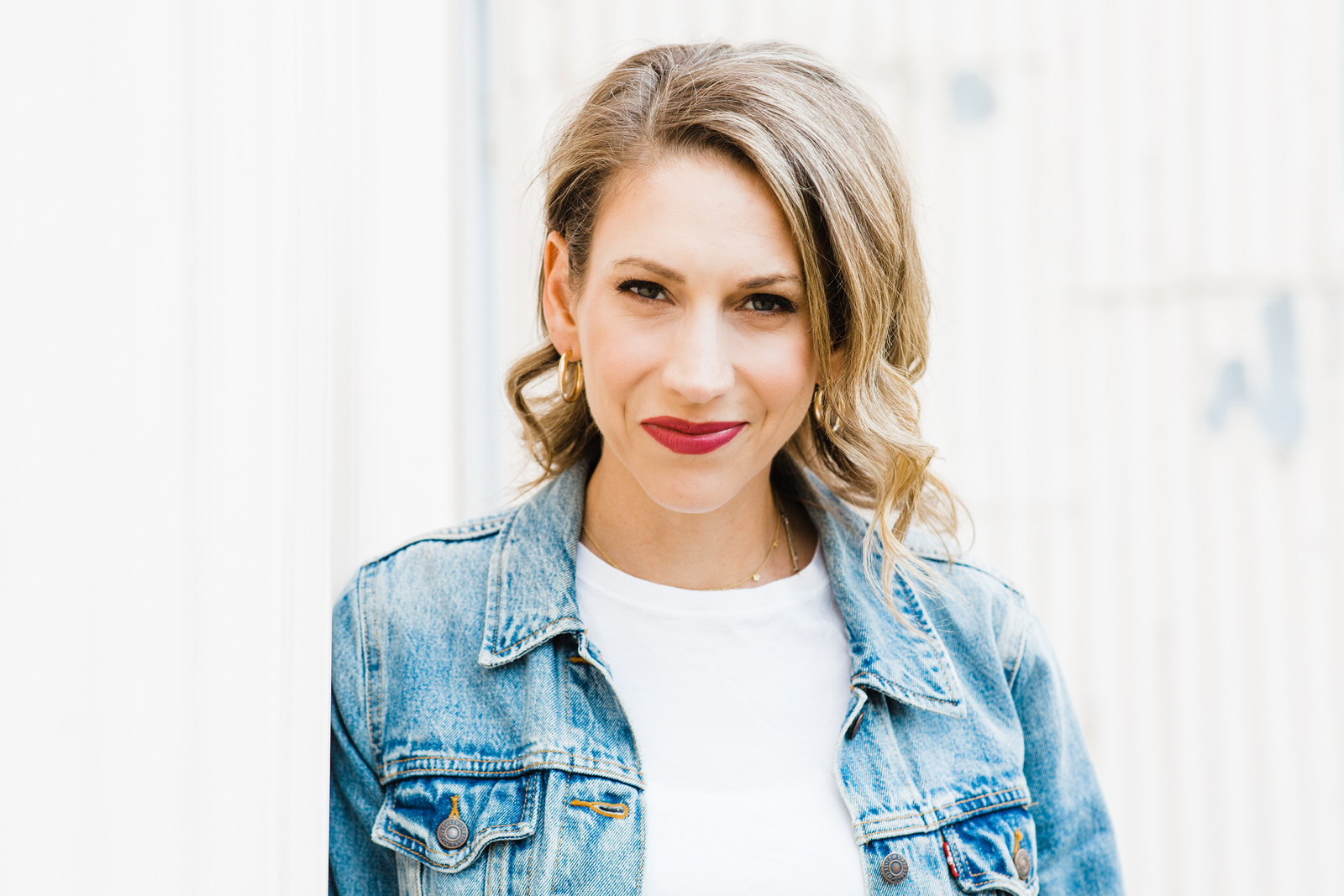 Portrait of a blonde woman in a jean jacket on Granville Island by Vancouver Portrait Photographer Michele Mateus