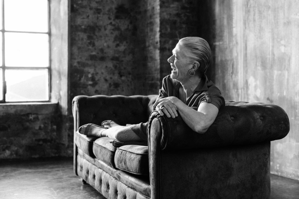 Editorial Portrait of an women in her sixties on a vintage couch in a warehouse taken by vancouver portrait photographer Michele Mateus