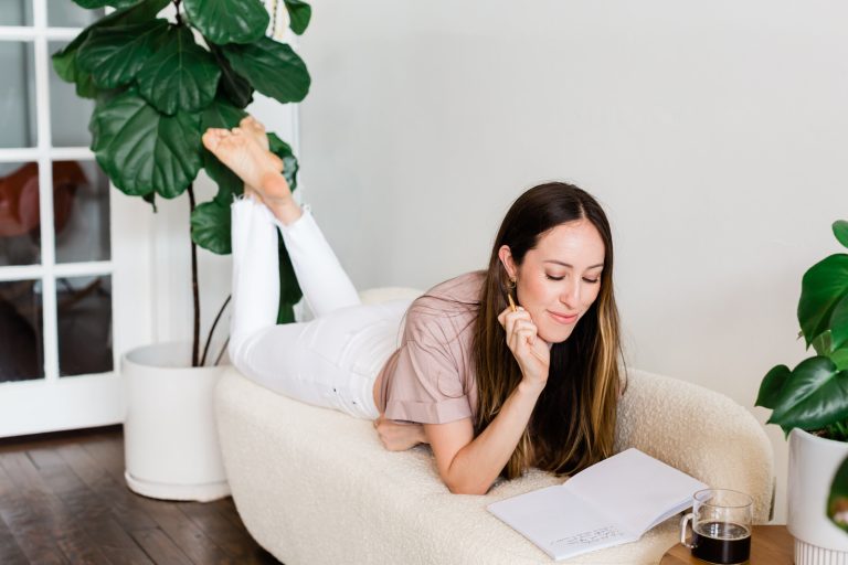Portrait of a woman with long brown hair writing in her journal by vancouver photographer Michele Mateus