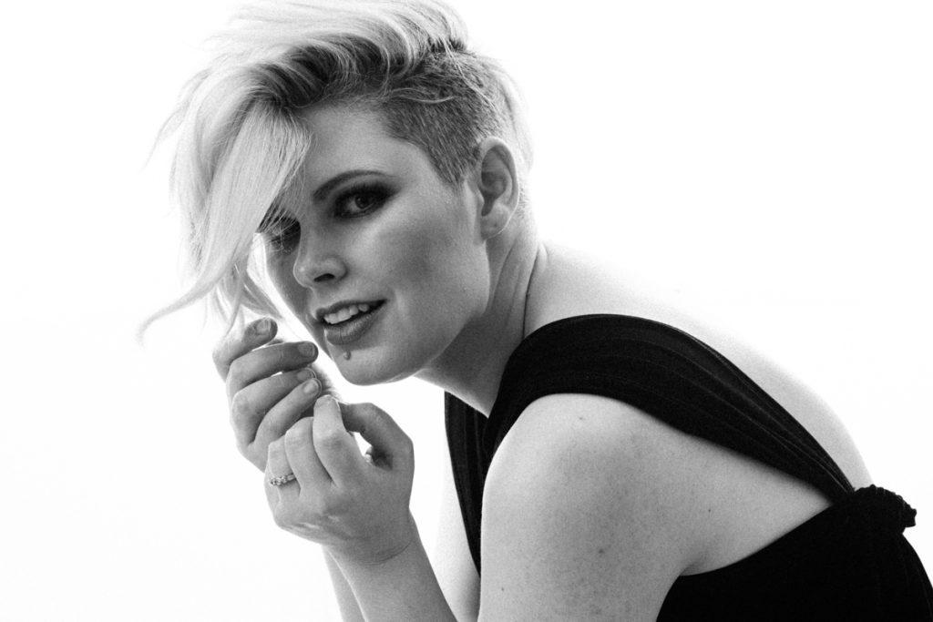 Contemporary black and white portrait of a blonde woman with short hair in a black dress photographed by Vancouver Portrait Photographer Michele Mateus