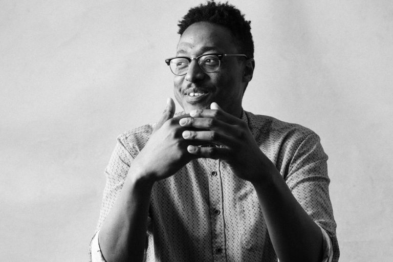 Black and white portrait of a Black man by Vancouver photographer Michele Mateus